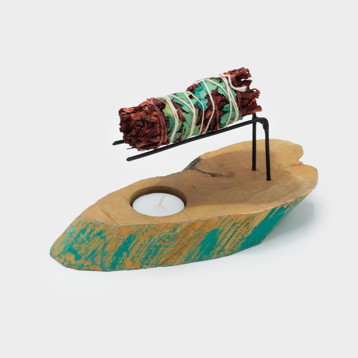 Palo Santo Heater. handcrafted from Greewash Gamel Wood supporting a smudge stick and an indentation for a tea light