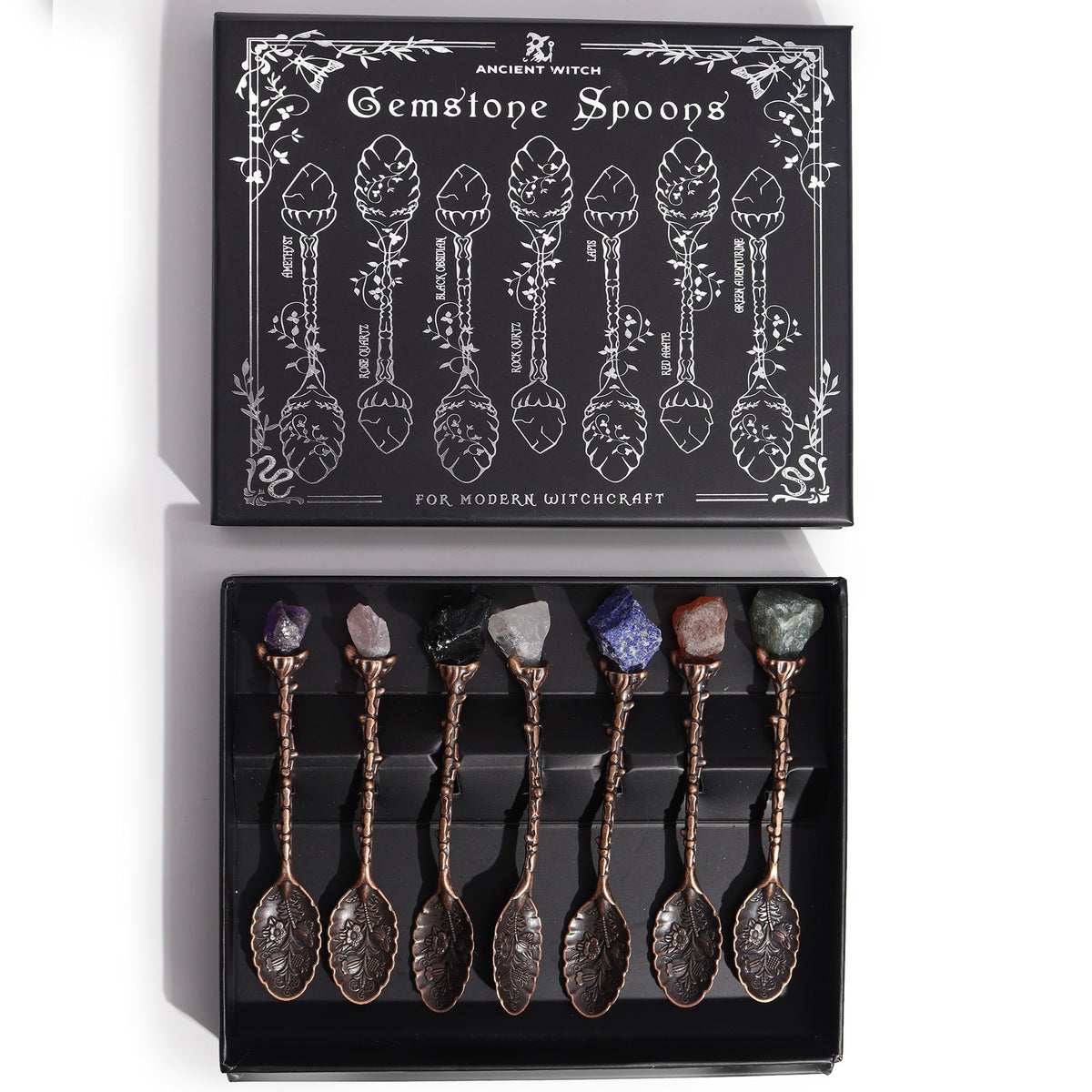 Set of gemstone spoons in a black box with decorative design