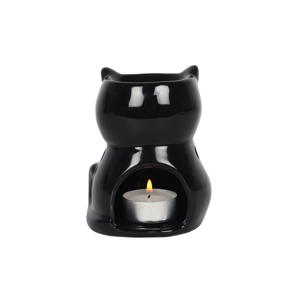 Black cat-shaped candle warmer with a lit candle inside on a white background