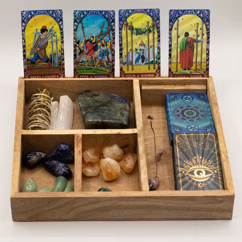 Wooden box with tarot cards, crystals, and stones on a white background