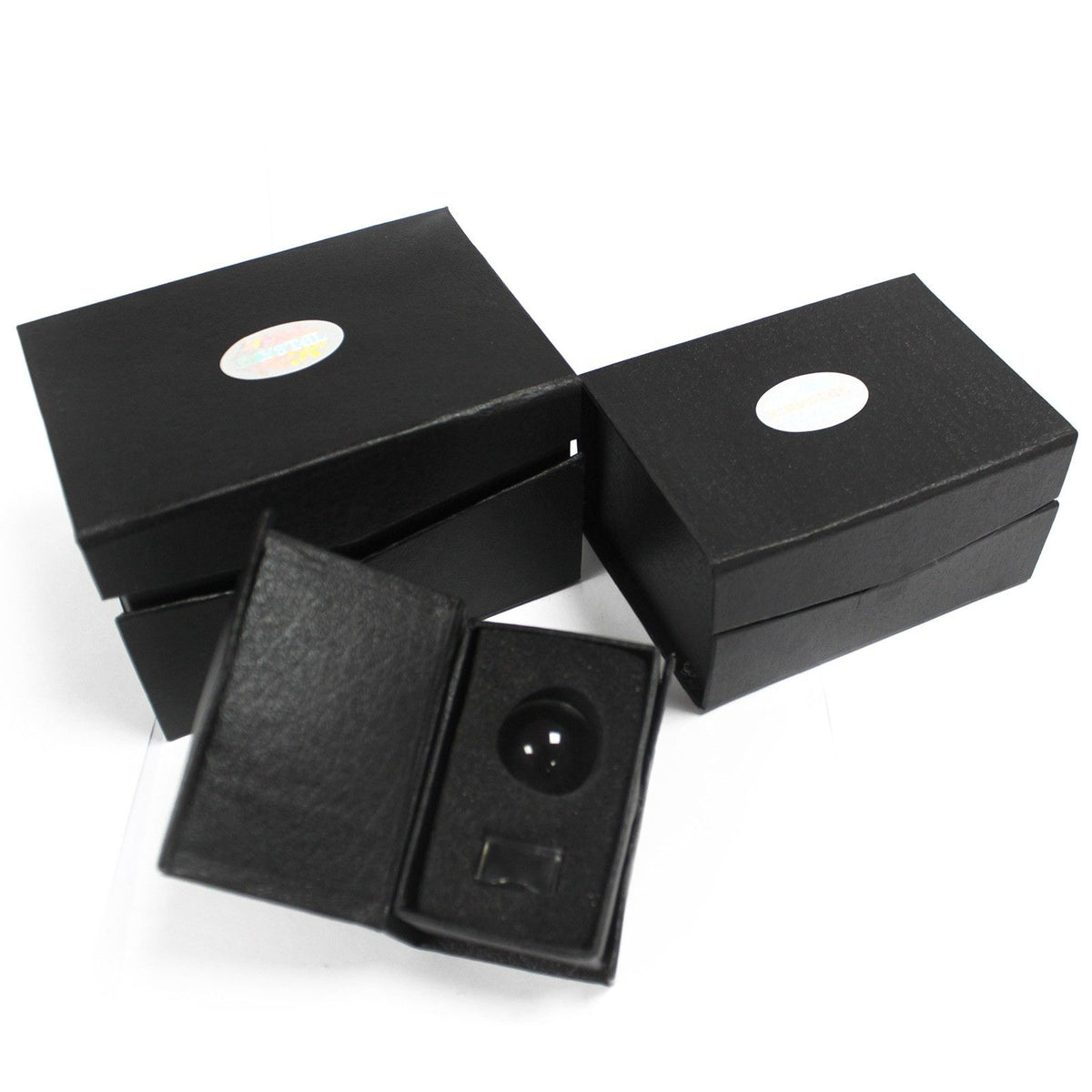 Black jewelry box with a round black object inside on a white background