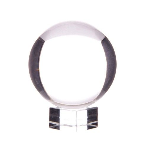 Clear crystal ball on a stand against a white background