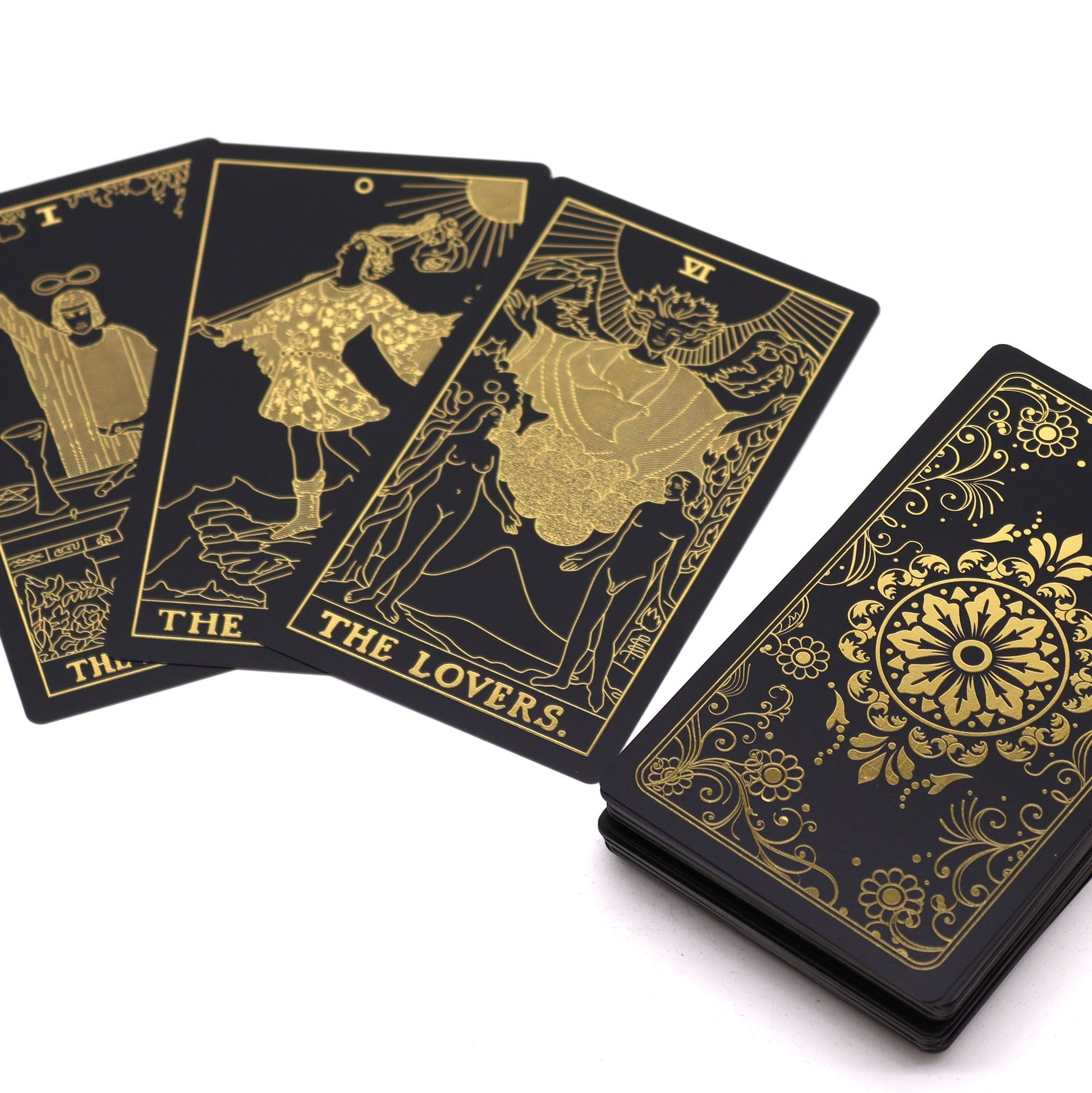 Black tarot cards with gold illustrations and 'The Lovers' card displayed.