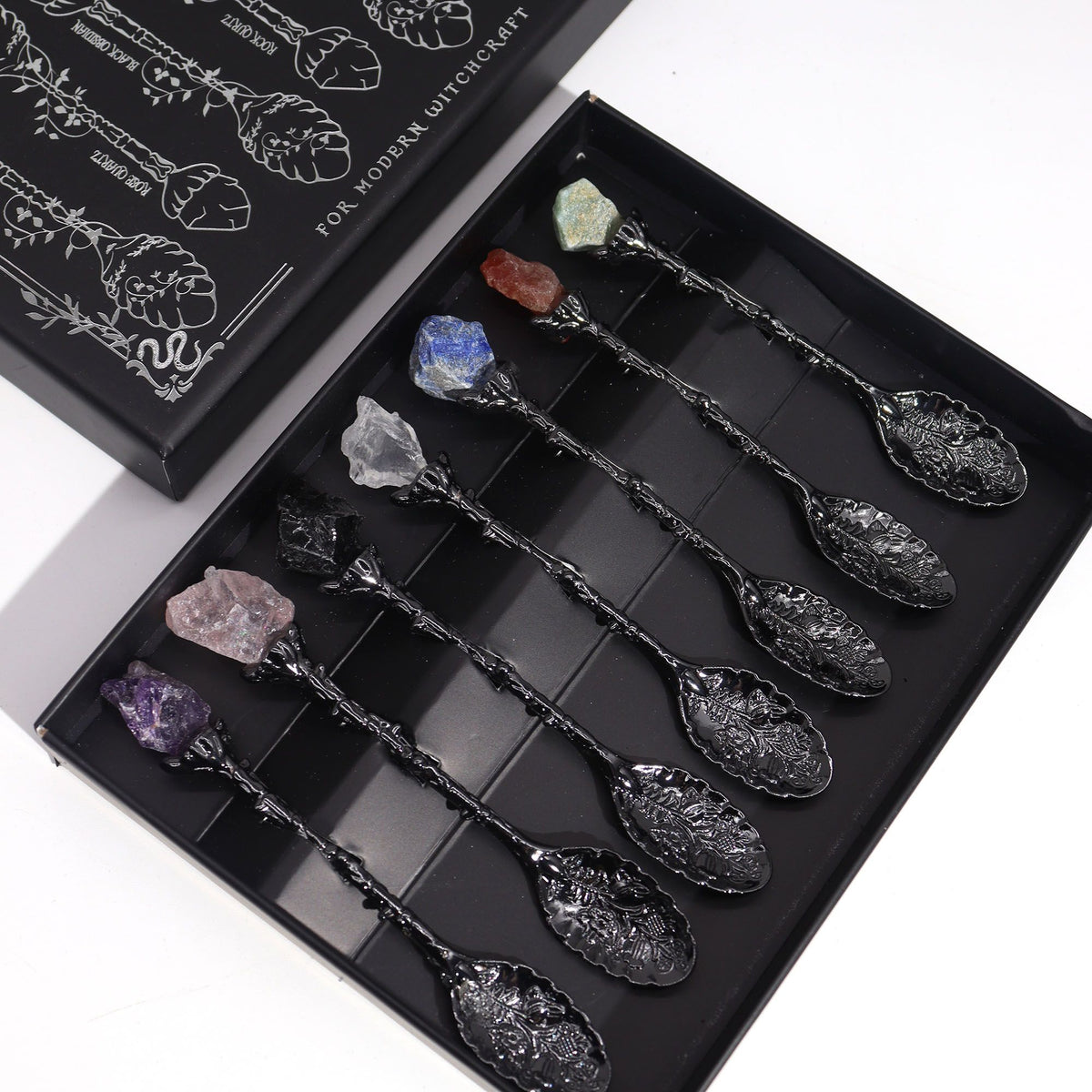 Set of decorative spoons with embedded crystals in a black box