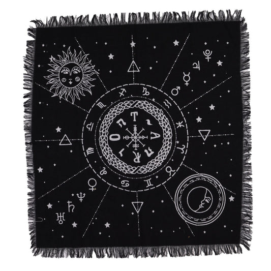 Black throw blanket with white symbols and fringes on a white background