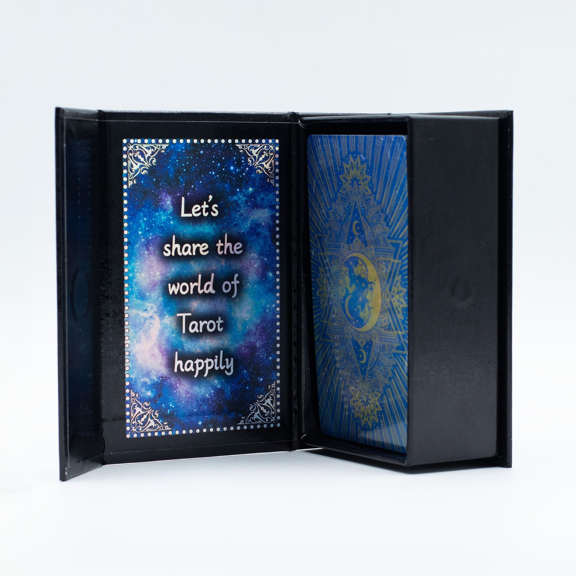 Black book with tarot card design and text on a blue fabric background