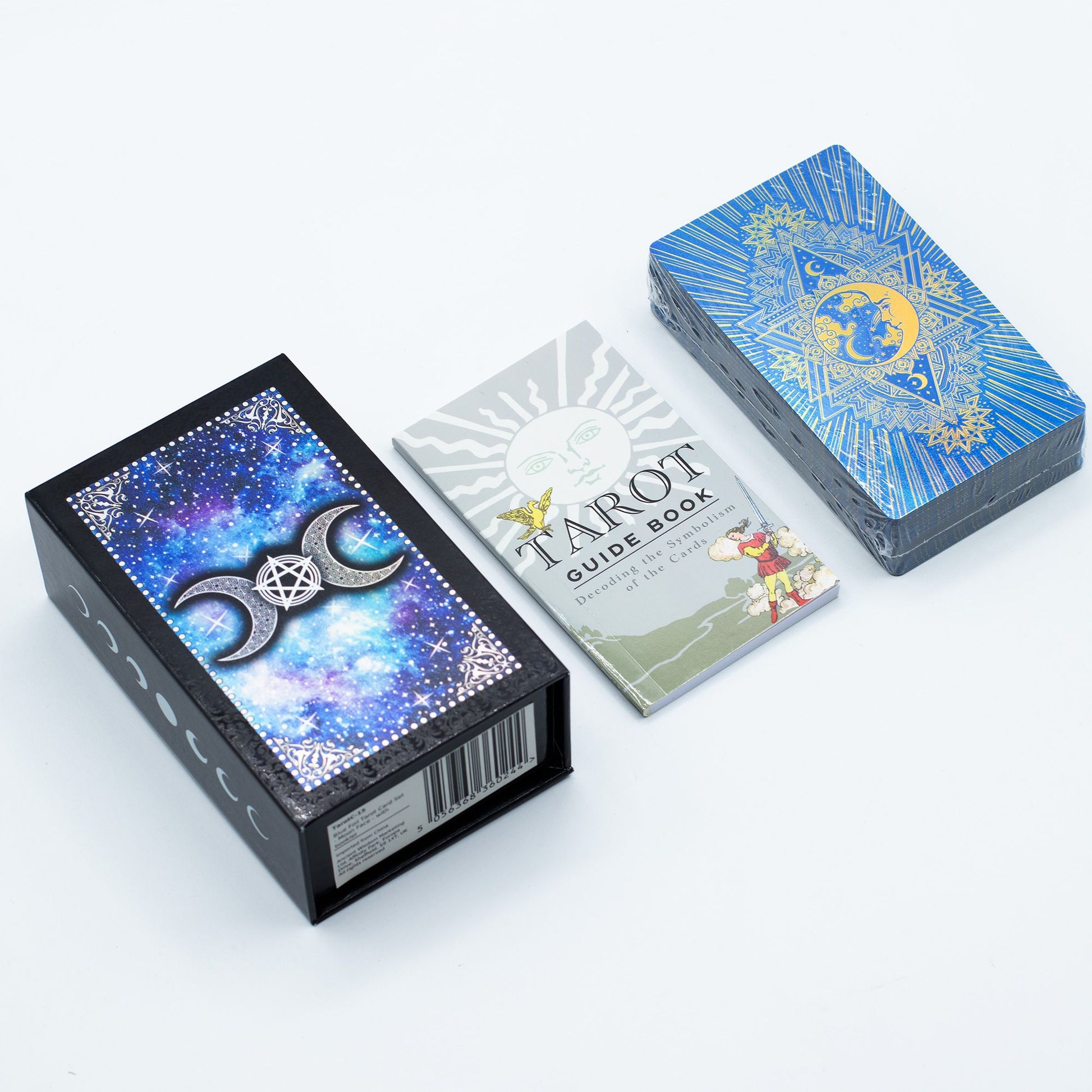 Wiccan or spiritual items including crystals, candles, and tarot cards on a wooden surface.