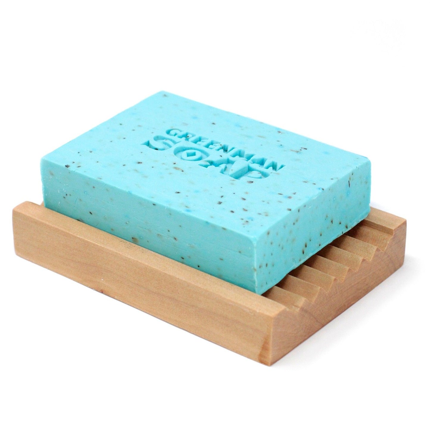 Greenman Soap bar on a wooden soap dish with a white background
