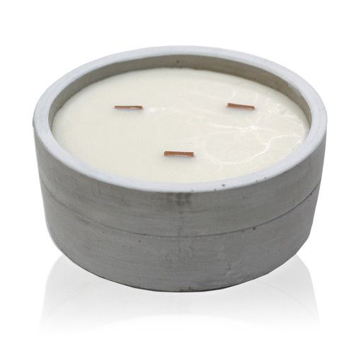 Candle in a concrete holder on a white background