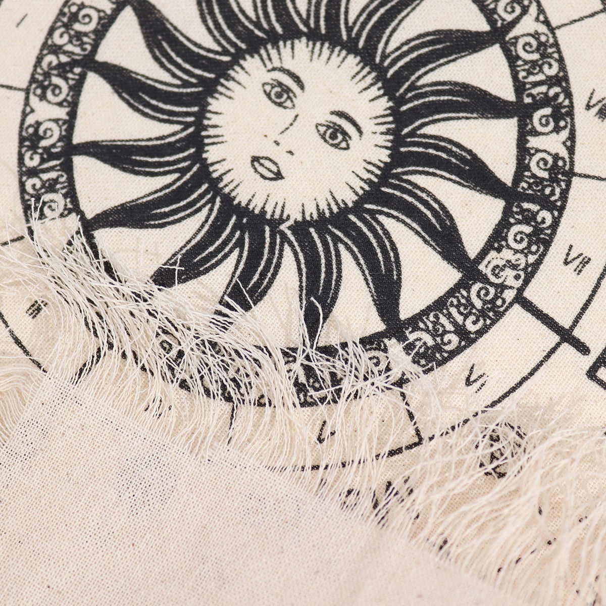 Black sun design with face on a textured beige background