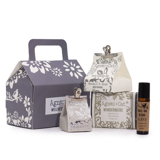 Collection of Agnes + Cat wellness products including a box, bottle, and other packaging on a white background.