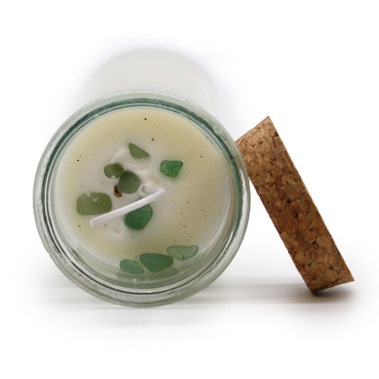 Candle in a glass jar with a wooden lid on a white background