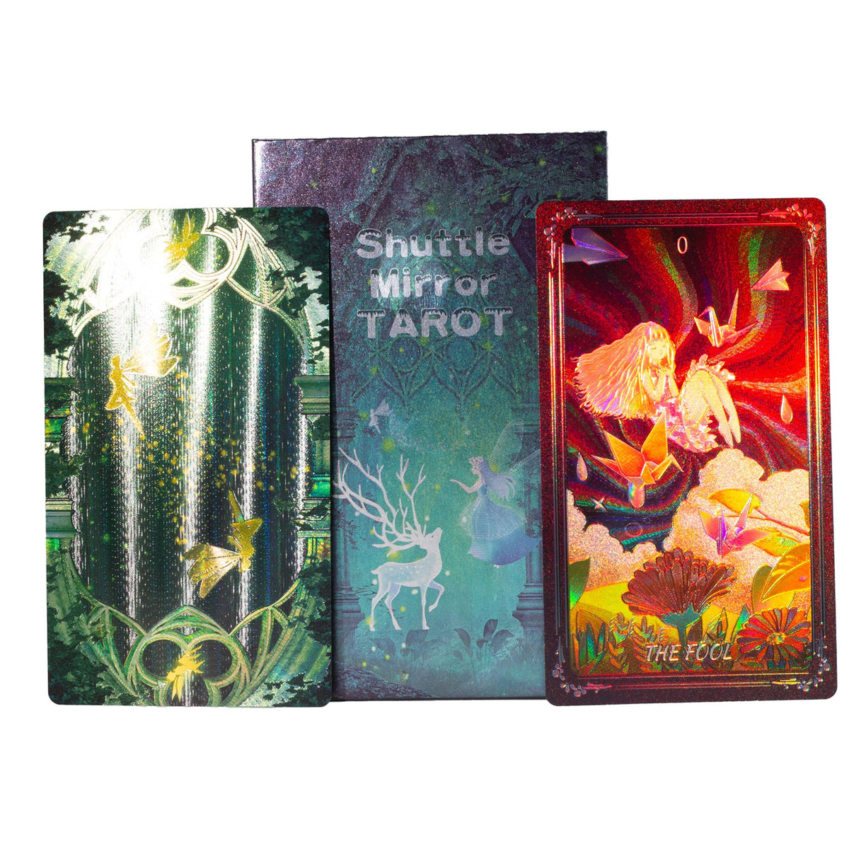 Three tarot cards fanned out against a white background: 'The Fool' in red with a fairy illustration, 'Shuttle Mirror Tarot' in teal with a deer and mirror design, and another card in green with a fairy and gold details.
