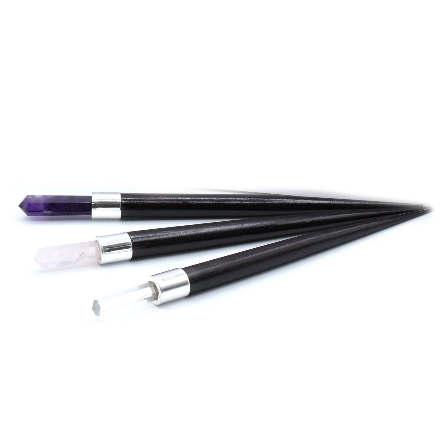 Three black and silver wands on a white background