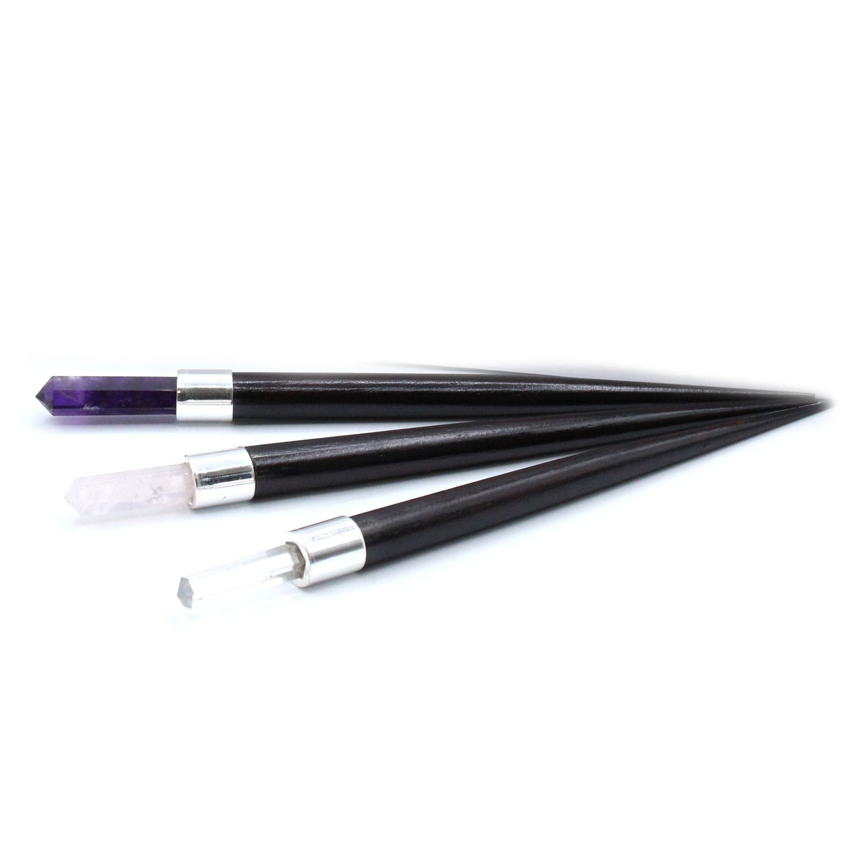 Three black and silver wands on a white background