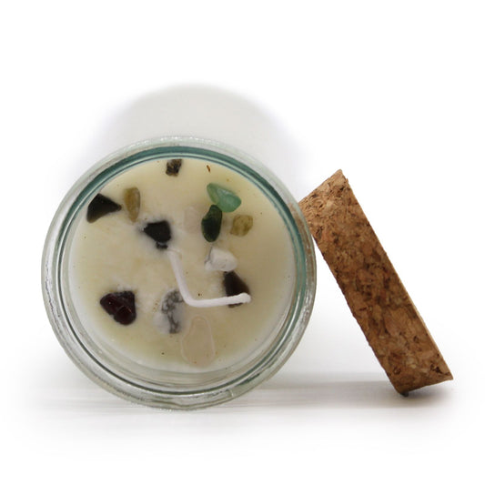 Candle in a glass jar with decorative elements on a white background