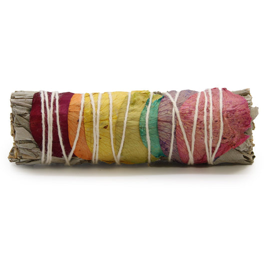 A smudge stick bundle of sage leaves tied together, traditionally used in rituals of purification and cleansing, fragranced with delicate rose petals aligned to all seven chakras