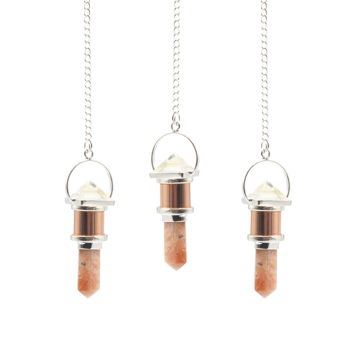 Three crystal pendulums on chains against a white background