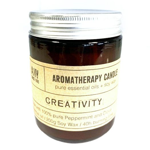 Aromatherapy candle labeled 'Creativity' with lavender flowers on a white background