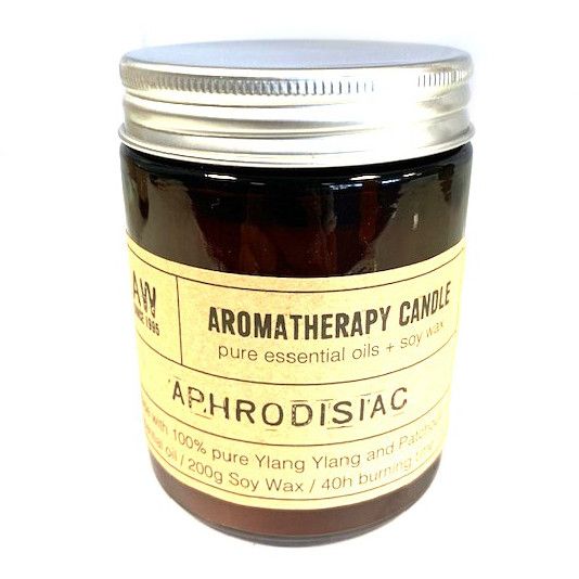 Aromatherapy candle jar labeled 'Aphrodisiac' on a white background