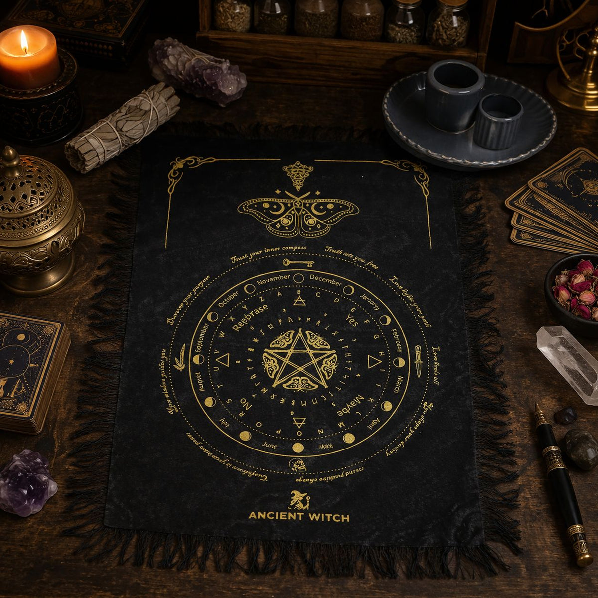 Black cloth with gold astrological design on a dark background with candles and crystals.