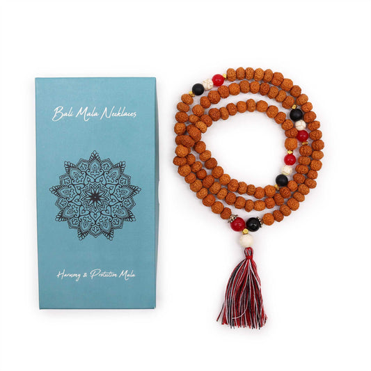 Bali Mala necklace with tassel next to a blue packaging box on a white background
