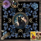 A square decorative art print or poster featuring a dark fantasy illustration of a black cat in a circular frame surrounded by blue flowers, crescent moons, and mystical symbols on a black background.